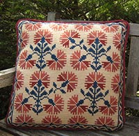 Floral needlepoint kit Carnaton in brick, navy on pale honey ground