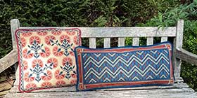 Chevron geometric long lumbar needlepoint cushion in dark red, old blues, copper and sand colors with Carnation pillow companion 